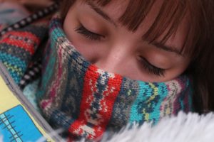 Cold: Woman with face wrapped in a scarf